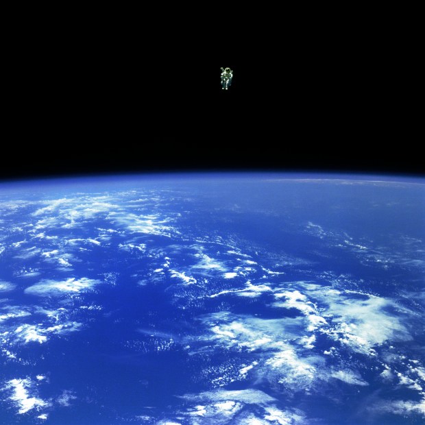 Mission Specialist Bruce McCandless II, is seen further away from the confines and safety of his ship than any previous astronaut has ever been. This space first was made possible by the Manned Manuevering Unit or MMU, a nitrogen jet propelled backpack. After a series of test maneuvers inside and above Challenger's payload bay, McCandless went "free-flying" to a distance of 320 feet away from the Orbiter. This stunning orbital panorama view shows McCandless out there amongst the black and blue of Earth and space. Credit: NASA